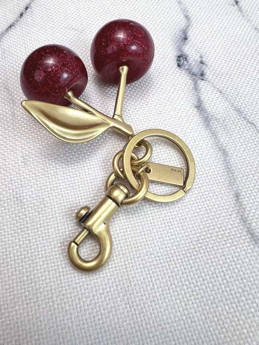 Coach cherry charm